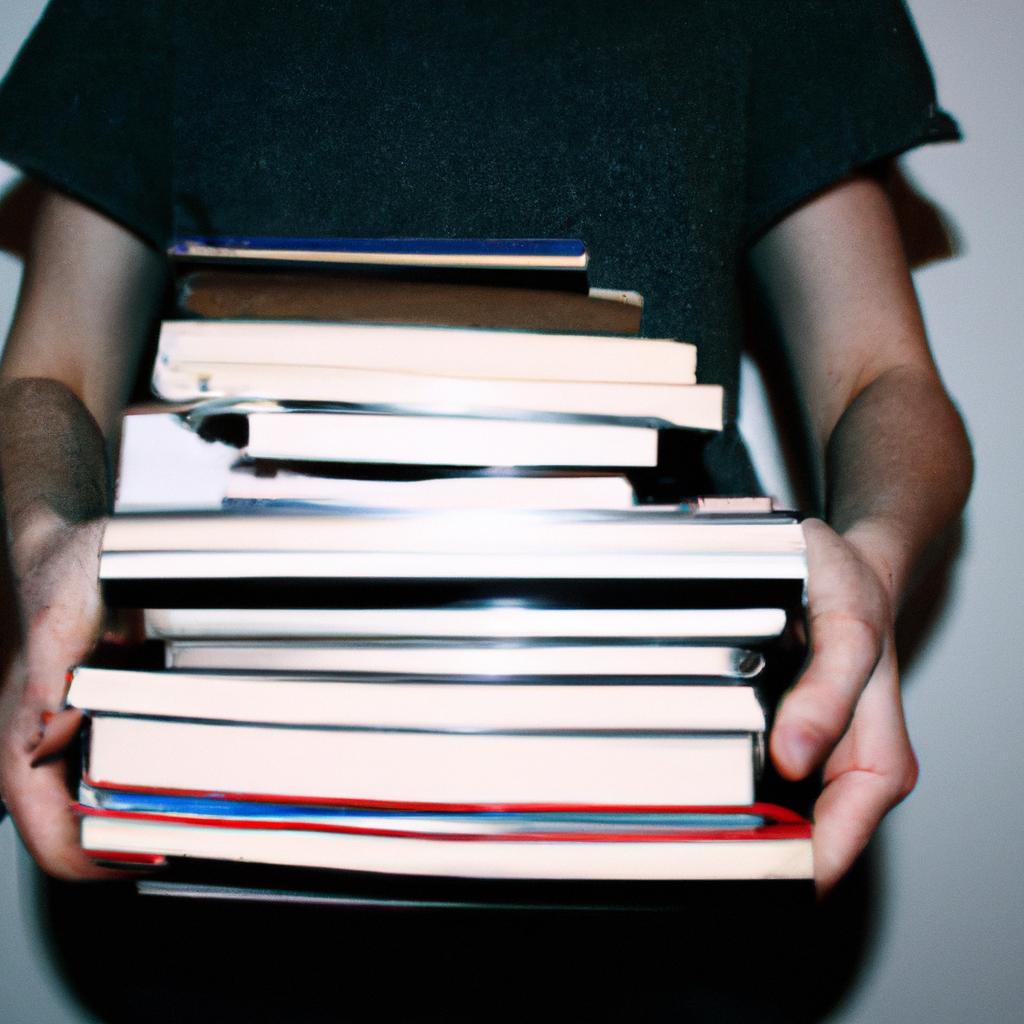 Person holding a stack of books